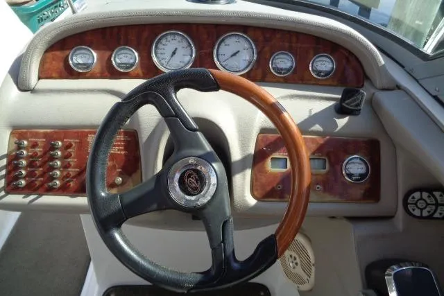 Slide: The Image of Dashboard of a 2006 Cobalt 282 boat with gauges and wood-trimmed steering wheel. - 13