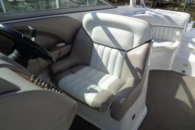 Slide: The Image of 2006 Cobalt 282 boat interior with plush seating and steering wheel. - 15