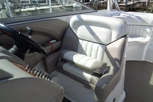Slide: The Image of Interior of a 2006 Cobalt 282 boat featuring a sleek steering wheel and plush seating. - 16