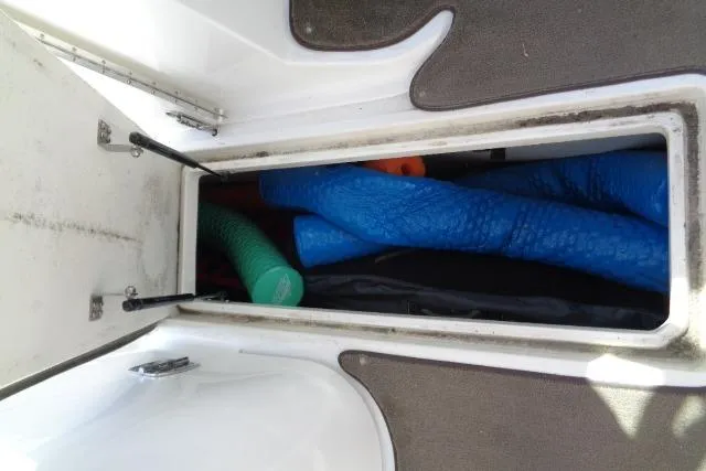 Slide: The Image of Storage compartment on a 2006 Cobalt 282 boat with colorful pool noodles. - 21