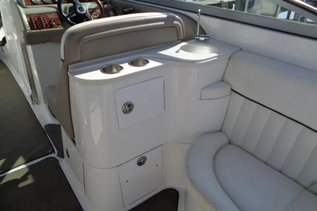 Slide: The Image of Interior of a 2006 Cobalt 282 boat featuring seating and cup holders. - 24