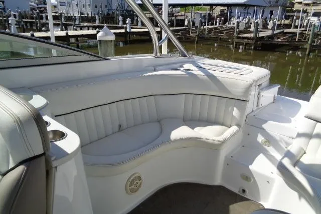 Slide: The Image of 2006 Cobalt 282 boat interior with white seating and dock view. - 26