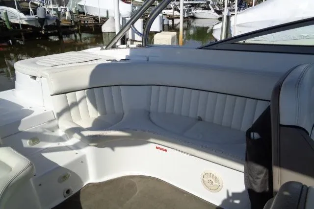 Slide: The Image of 2006 Cobalt 282 boat interior with white cushioned seating and sleek design. - 28