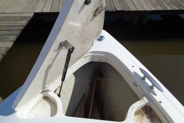 Slide: The Image of Open storage compartment on a 2006 Cobalt 282 boat near a wooden dock. - 3