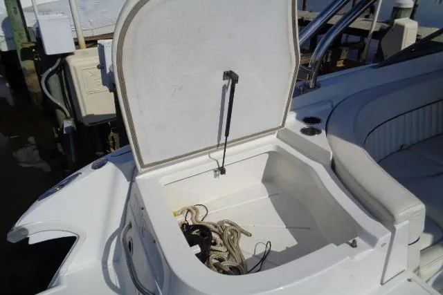 Slide: The Image of Open storage compartment on a 2006 Cobalt 282 boat with ropes inside. - 32
