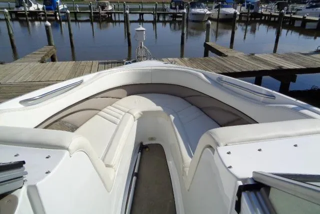 Slide: The Image of 2006 Cobalt 282 boat with white seating, docked at a marina. - 4