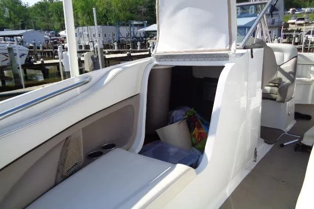 Slide: The Image of 2006 Cobalt 282 boat interior with open storage compartment at marina. - 8