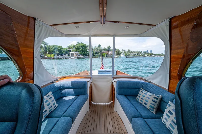 Slide: The Image of Interior view of 2011 Hinckley Picnic Boat 37 MKIII with blue seating and waterfront scenery. - 10