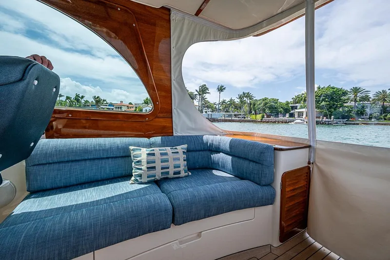 Slide: The Image of Interior of 2011 Hinckley Picnic Boat 37 MKIII with blue seating and scenic water view. - 11