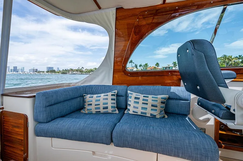 Slide: The Image of Interior of 2011 Hinckley Picnic Boat 37 MKIII with blue seating and ocean view. - 12