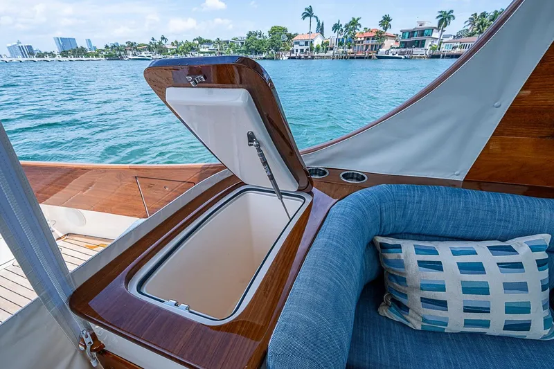 Slide: The Image of Hinckley Picnic Boat 37 MKIII interior with open storage, blue seating, and ocean view. - 13