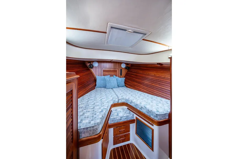 Slide: The Image of Luxurious cabin interior of 2011 Hinckley Picnic Boat 37 MKIII with wooden finish and cozy bedding. - 17