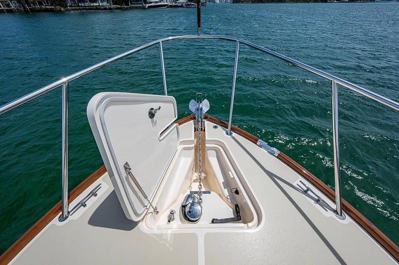 Slide: The Image of Hinckley Picnic Boat 37 MKIII 2011 bow with open anchor hatch on calm water. - 20