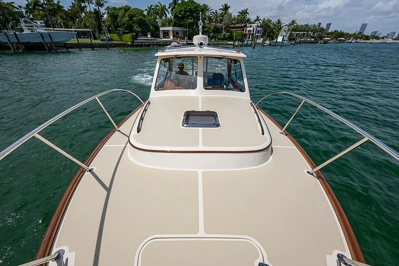 Slide: The Image of 2011 Hinckley Picnic Boat 37 MKIII cruising on a scenic waterway. - 21
