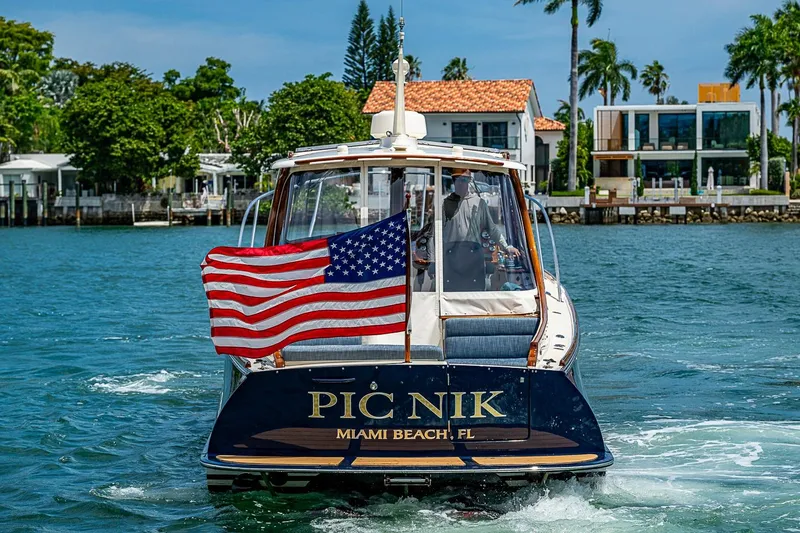 Slide: The Image of Hinckley Picnic Boat 37 MKIII cruising in Miami Beach, 2011, with American flag. - 4