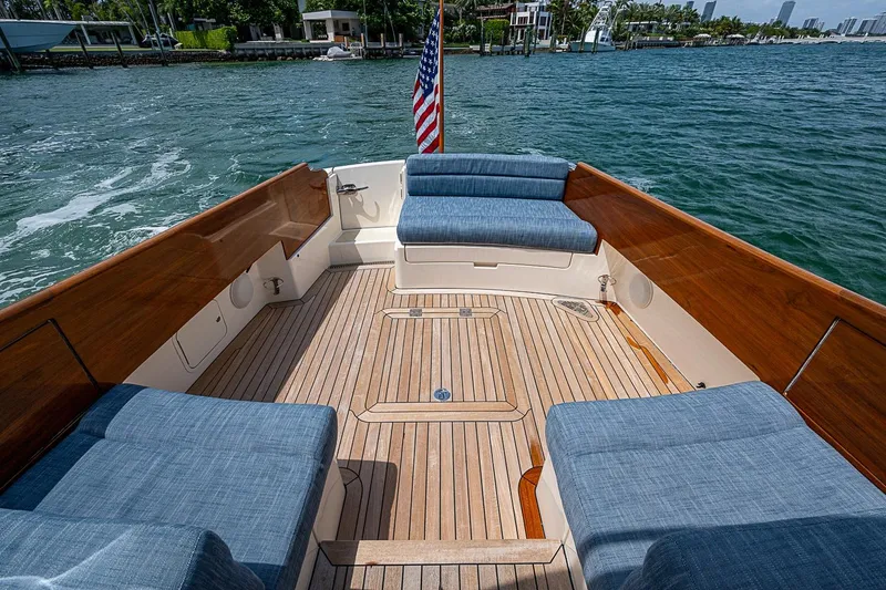 Slide: The Image of Hinckley Picnic Boat 37 MKIII 2011 with teak deck and blue seating, cruising on water. - 5