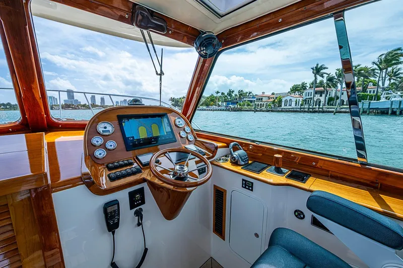 Slide: The Image of Interior view of 2011 Hinckley Picnic Boat 37 MKIII helm with waterfront scenery. - 9
