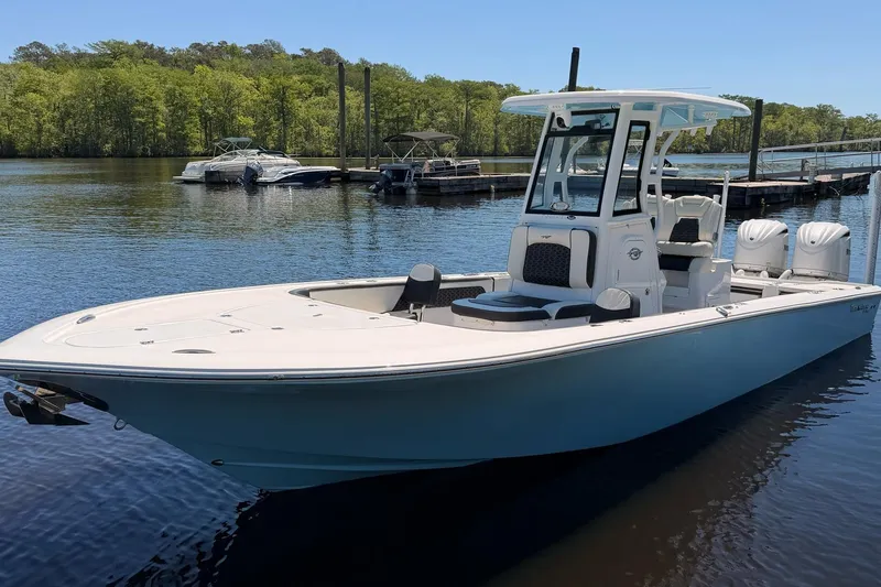 The Image of 2024 Tidewater 2700 Carolina Bay boat docked on a serene lake. - 1