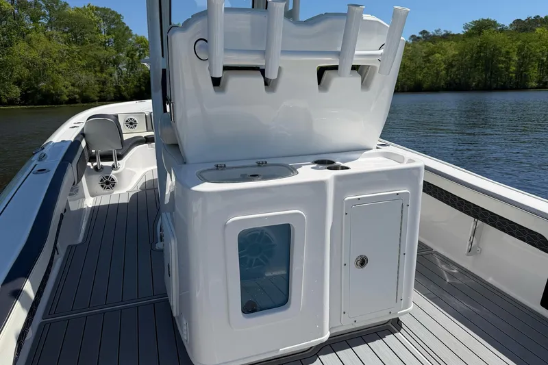 Slide: The Image of 2024 Tidewater 2700 Carolina Bay boat interior with rod holders and storage compartments. - 11