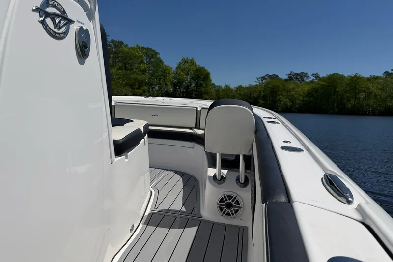 Slide: The Image of 2024 Tidewater 2700 Carolina Bay boat interior with seating and water view. - 13
