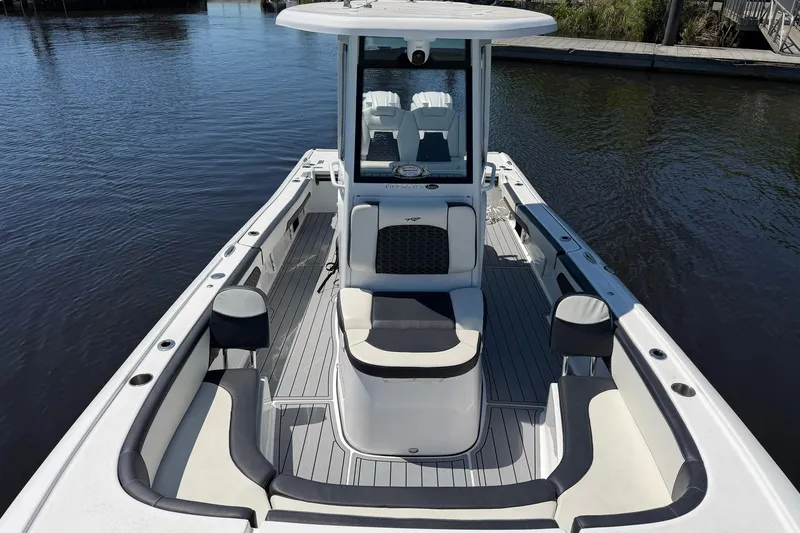 Slide: The Image of 2024 Tidewater 2700 Carolina Bay boat with sleek design and spacious seating on calm water. - 5