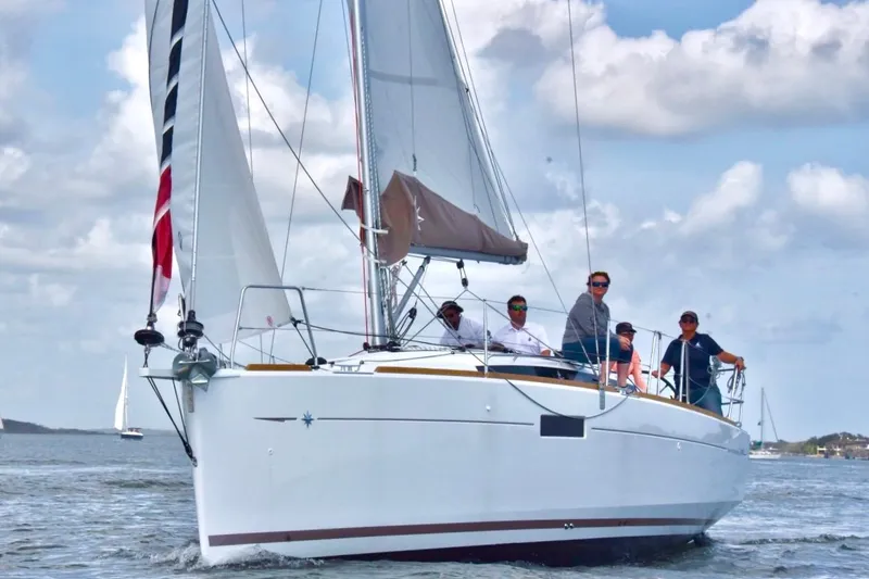 Slide: The Image of 2019 Jeanneau Sun Odyssey 349 sailing with crew under cloudy skies. - 2