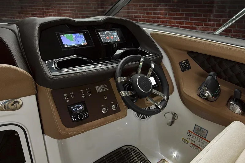 Slide: The Image of Manufacturer Provided Image: 2017 Cobalt R35 boat dashboard with steering wheel, navigation screens, and control panel. - 4