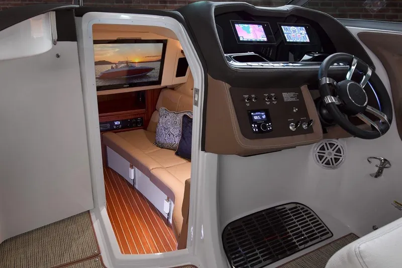 Slide: The Image of Manufacturer Provided Image: 2017 Cobalt R35 boat interior with modern dashboard and cozy cabin. - 5
