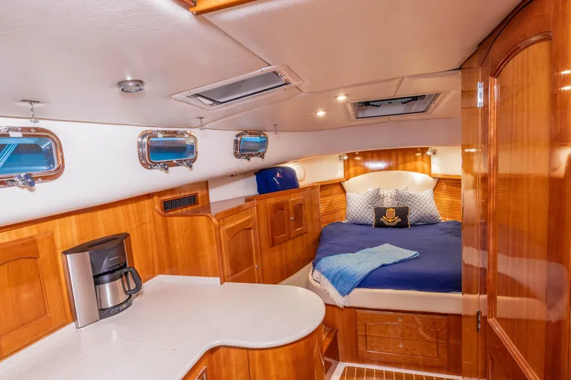 Slide: The Image of Luxurious 2007 Legacy 32 yacht kitchen with wood cabinetry, stainless appliances, and modern fixtures. - 10
