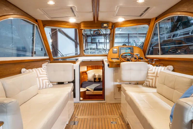Slide: The Image of Luxurious cabin interior of 2007 Legacy 32 Express yacht with cozy bedding and wooden accents. - 12