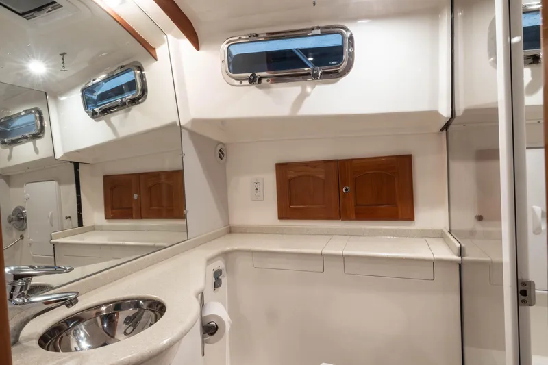 Slide: The Image of Luxurious interior of 2007 Legacy 32 Express yacht with plush seating and wooden accents. - 13