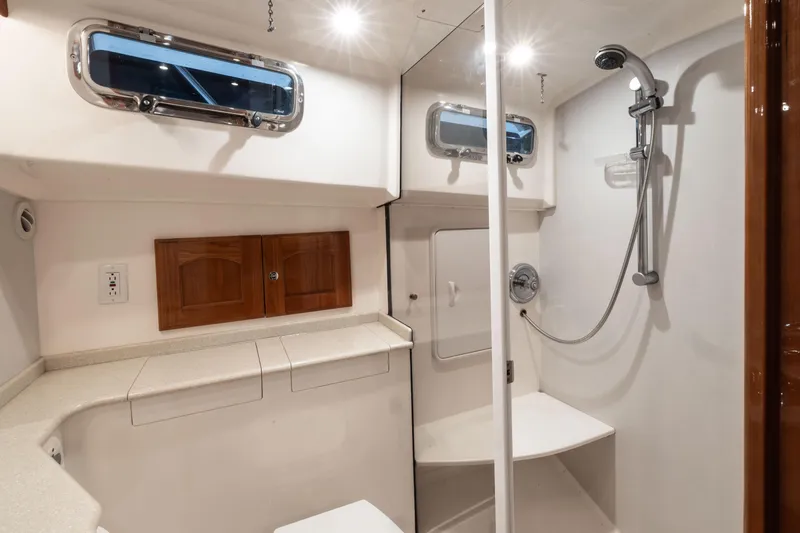 Slide: The Image of 2007 Legacy 32 Express yacht bathroom with stainless steel sink and wooden cabinets. - 14
