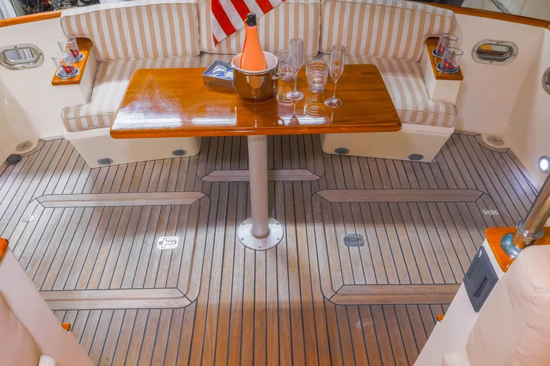 Slide: The Image of 2007 Legacy 32 Express yacht bathroom with shower, wooden cabinets, and porthole window. - 15