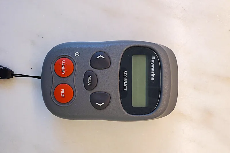 Slide: The Image of Remote control for 2007 Legacy 32 Express boat, featuring directional and function buttons. - 19