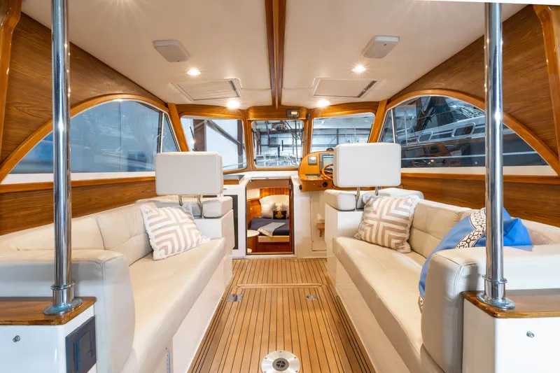 Slide: The Image of Luxurious interior of 2007 Legacy 32 Express yacht with elegant wood finish and plush seating. - 2