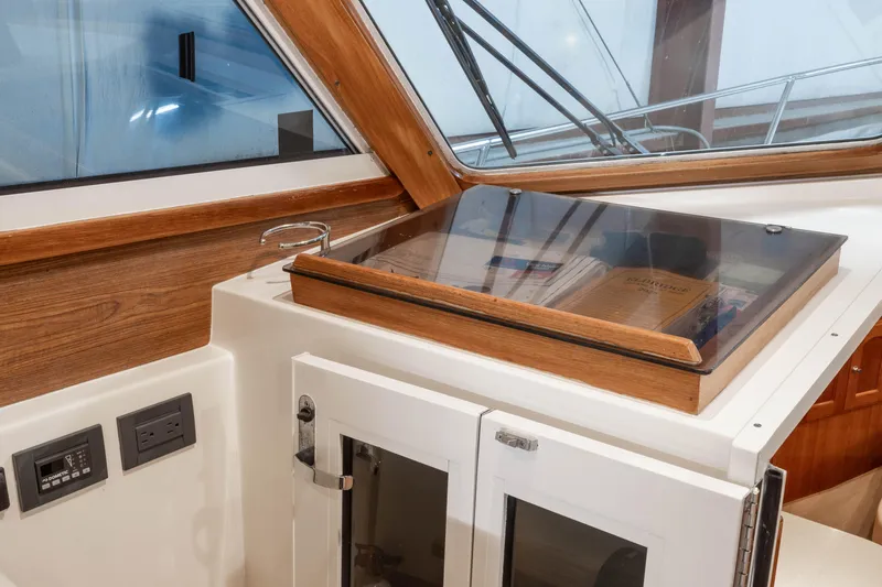 Slide: The Image of Interior view of 2007 Legacy 32 Express boat with wooden accents and navigation equipment. - 6