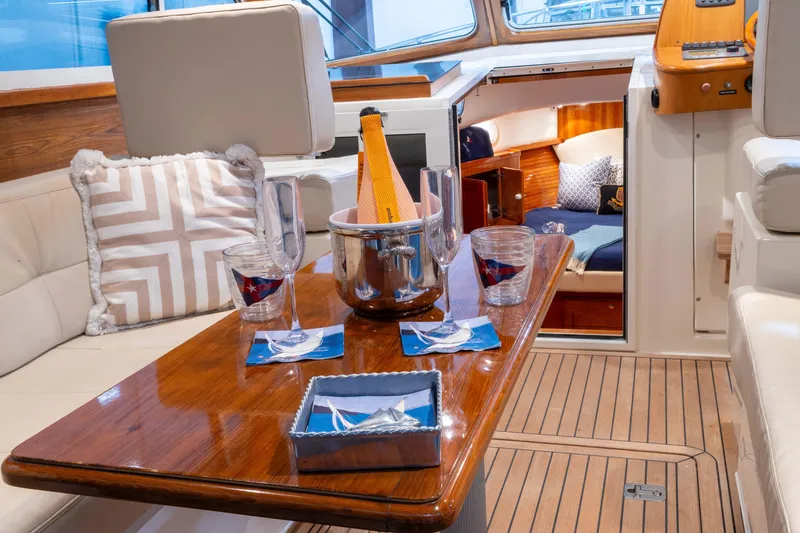 Slide: The Image of Luxurious interior of 2007 Legacy 32 Express yacht with elegant dining setup and cozy cabin. - 8