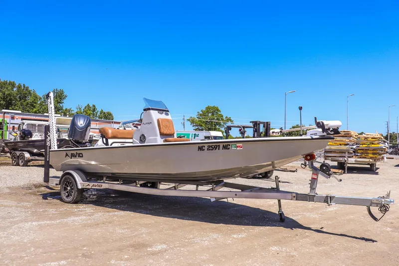 The Image of 2024 Avid 21 FSX boat on trailer in outdoor setting, clear blue sky. - 1