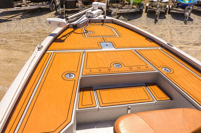 Slide: The Image of 2024 Avid 21 FSX boat deck with orange non-slip surface and fishing ruler. - 10