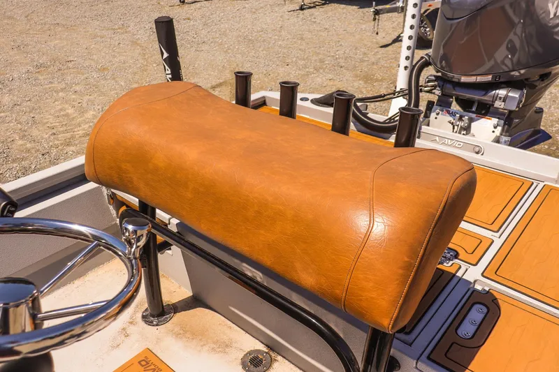 Slide: The Image of 2024 Avid 21 FSX boat with tan leather seat and fishing rod holders. - 11