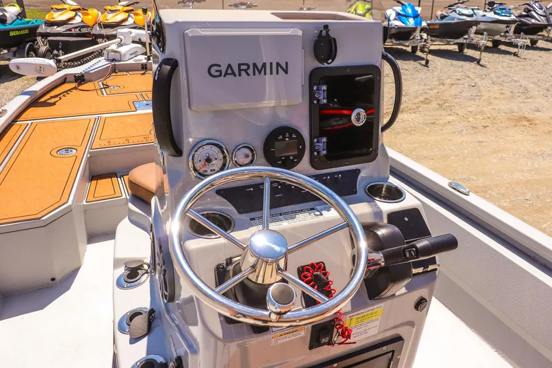 Slide: The Image of 2024 Avid 21 FSX boat dashboard with Garmin navigation system and steering wheel. - 12