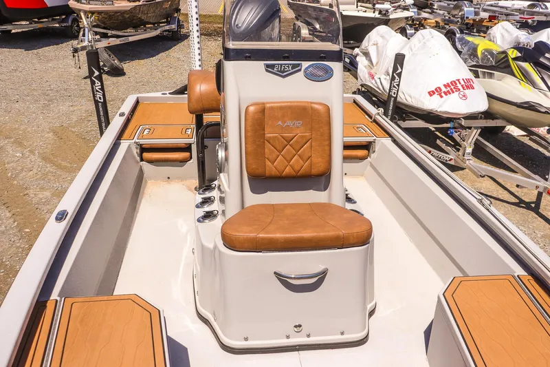 Slide: The Image of 2024 Avid 21 FSX boat interior with tan leather seating and sleek design. - 14