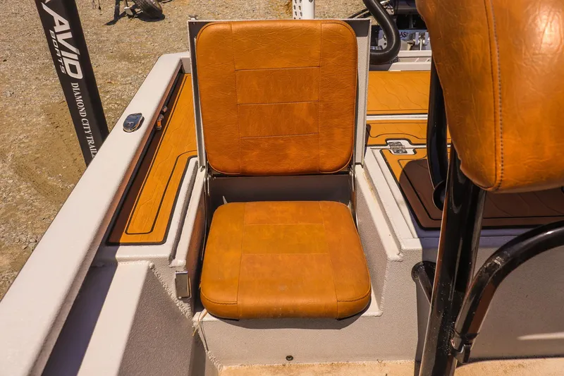 Slide: The Image of 2024 Avid 21 FSX boat with brown leather seating and sleek design. - 15