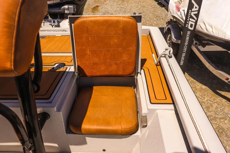 Slide: The Image of 2024 Avid 21 FSX boat seat with brown leather upholstery and sleek design. - 16