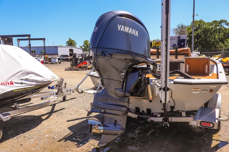 Slide: The Image of 2024 Avid 21 FSX boat with Yamaha outboard motor in a sunny outdoor setting. - 18