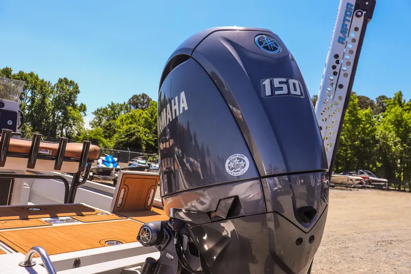 Slide: The Image of 2024 Avid 21 FSX boat with Yamaha 150 engine, parked outdoors. - 20