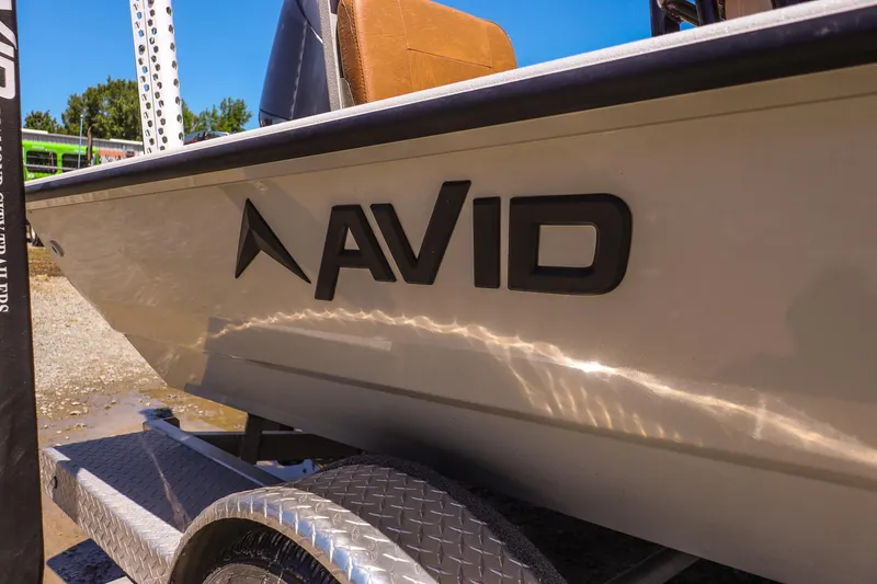 Slide: The Image of 2024 Avid 21 FSX boat on trailer, showcasing sleek design and branding. - 22