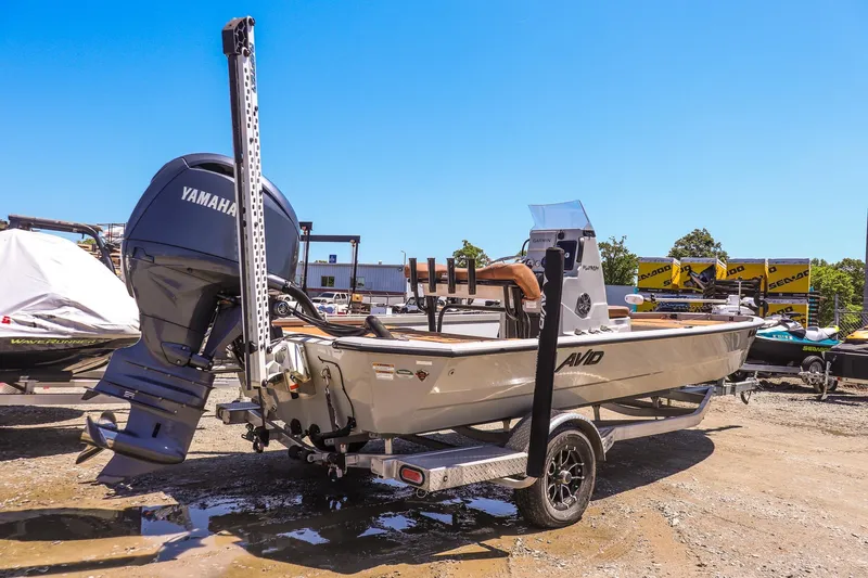 Slide: The Image of 2024 Avid 21 FSX boat with Yamaha engine on trailer in sunny outdoor setting. - 3