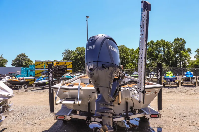 Slide: The Image of 2024 Avid 21 FSX boat with Yamaha 150 engine, parked outdoors on a sunny day. - 4