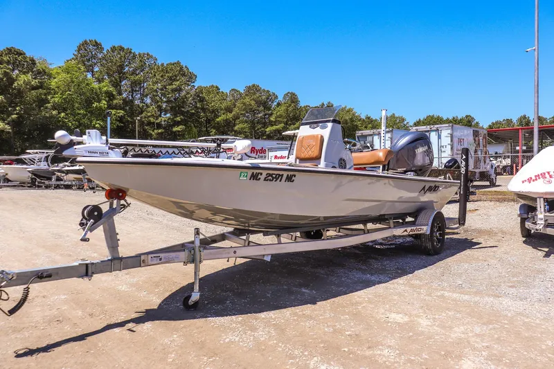Slide: The Image of 2024 Avid 21 FSX boat on trailer in outdoor lot, sunny day. - 6
